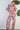 Weezie D. Playful Printed Jumpsuit in coral print. Our  jumpsuit has an elastic sweetheart neckline. Wear to your captain's dinner on your upcoming cruise, bridal or baby showers, day parties or date.