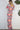 Weezie D. Playful Printed Jumpsuit in coral print. Our jumpsuit has an elastic sweetheart neckline. Wear to your captain's dinner on your upcoming cruise, bridal or baby showers, day parties or date.