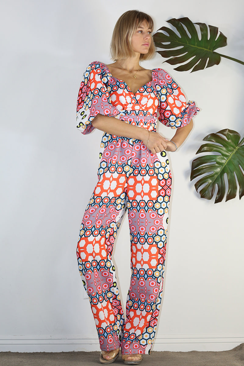 Weezie D. Playful Printed Jumpsuit in coral print. Our jumpsuit has an elastic sweetheart neckline. Wear to your captain's dinner on your upcoming cruise, bridal or baby showers, day parties or date.