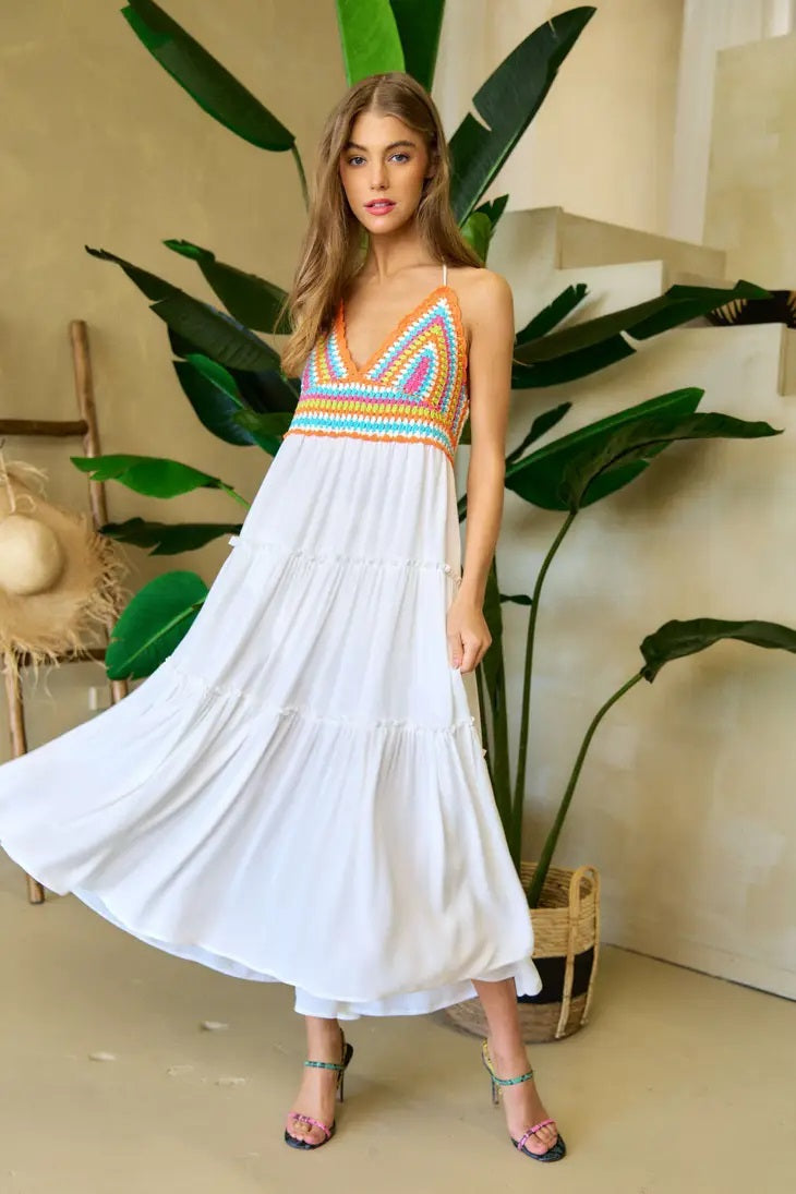 Weezie D. Neon Colored Crochet Halter Sundress dress in white has a tiered ruffled detail. The Smocked stretch back adds comfort. Dress includes a built in lining. Wear as a beach coverup or to a daytime party.
