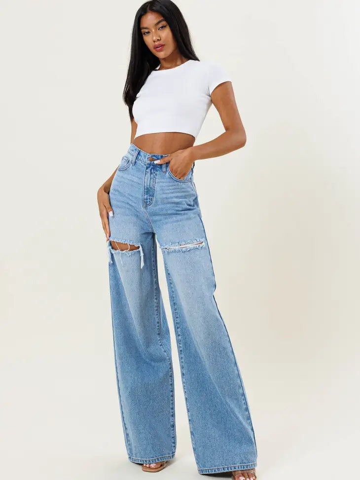 Weezie D light blue wash High Waist Distressed Wide Flood Denim Jeans are a MUST HAVE. Classic 5 pocket construction, hidden zip fly closure & belt loops. The thigh slit cuts add character to our denim. We love how the high waist fits with shorter length tops, t-shirts or tucked in blouse 57.8% Cotton 42.2% Gracell 