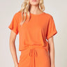 Weezie D color for the season is Tangelo Orange. Our Knit Top is comfy to lounge while still being cute. Super soft, ribbed stretch fabric has rolled up short sleeves & is a boxy crop relaxed fit. Wear with your favorite jeans or make it a matching set with our Tangelo Orange Drawstring Pants. Polyester Rayon Spandex