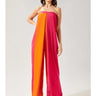 Weezie D Orange & Pink Color Block One Piece Jumpsuit is fun & perfect to take on vacation. It's strapless with side pockets, split pleat front leading into wide leg pants. 5% Nylon adds some stretch to this look. Add your favorite sun hat or headwrap for a balanced stylish look. 95% Polyester 5% Nylon.