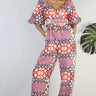Weezie D. Playful Printed Jumpsuit in coral print. Our  jumpsuit has an elastic sweetheart neckline. Wear to your captain's dinner on your upcoming cruise, bridal or baby showers, day parties or date.   