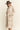Side view of beige houndstooth longline cardigan featuring a relaxed oversized fit and long sleeves