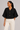 black dolman sleeve knit top with gold buttons front view