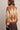 Back view of brown argyle brushed knit crew neck sweater with cream diamond pattern, balloon sleeves and ribbed hem