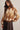 Front view of brown argyle brushed knit crew neck sweater featuring a cream and beige diamond pattern and long balloon sleeves