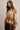 Side view of brown argyle brushed knit sweater showing its fuzzy texture, relaxed fit and ribbed cuffs