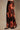 Side view of brown floral satin maxi skirt with oversized rust flowers