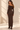Back view of chocolate brown off shoulder ribbed knit maxi dress with long sleeves and fitted ankle length silhouette