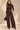 Front view of chocolate brown wide barrel leg knit pants with seam detailing, pockets and button tab hems