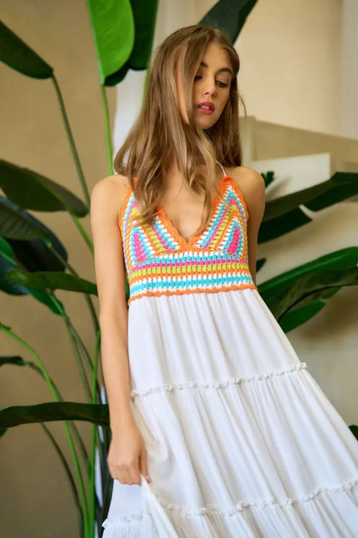 Weezie D. Neon Colored Crochet Halter Sundress dress in white has a tiered ruffled detail. The Smocked stretch back adds comfort. Dress includes a built in lining. Wear as a beach coverup or to a daytime party.