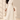 Front view of ivory faux leather midi skirt with asymmetrical overlay and flowing pleated chiffon hem