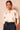 Front view of ivory satin braided neck cape blouse featuring a keyhole neckline, flowing cape overlay and relaxed fit