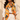 Orange baroque print silk blend scarf with black and gold chain motifs styled over an ivory blouse