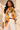Orange baroque print silk blend scarf with black and gold chain motifs styled over an ivory blouse