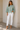 Front view of sage scalloped open knit bell sleeve sweater