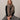 Taupe cashmere feel fringe wrap scarf styled around neck with black sweater