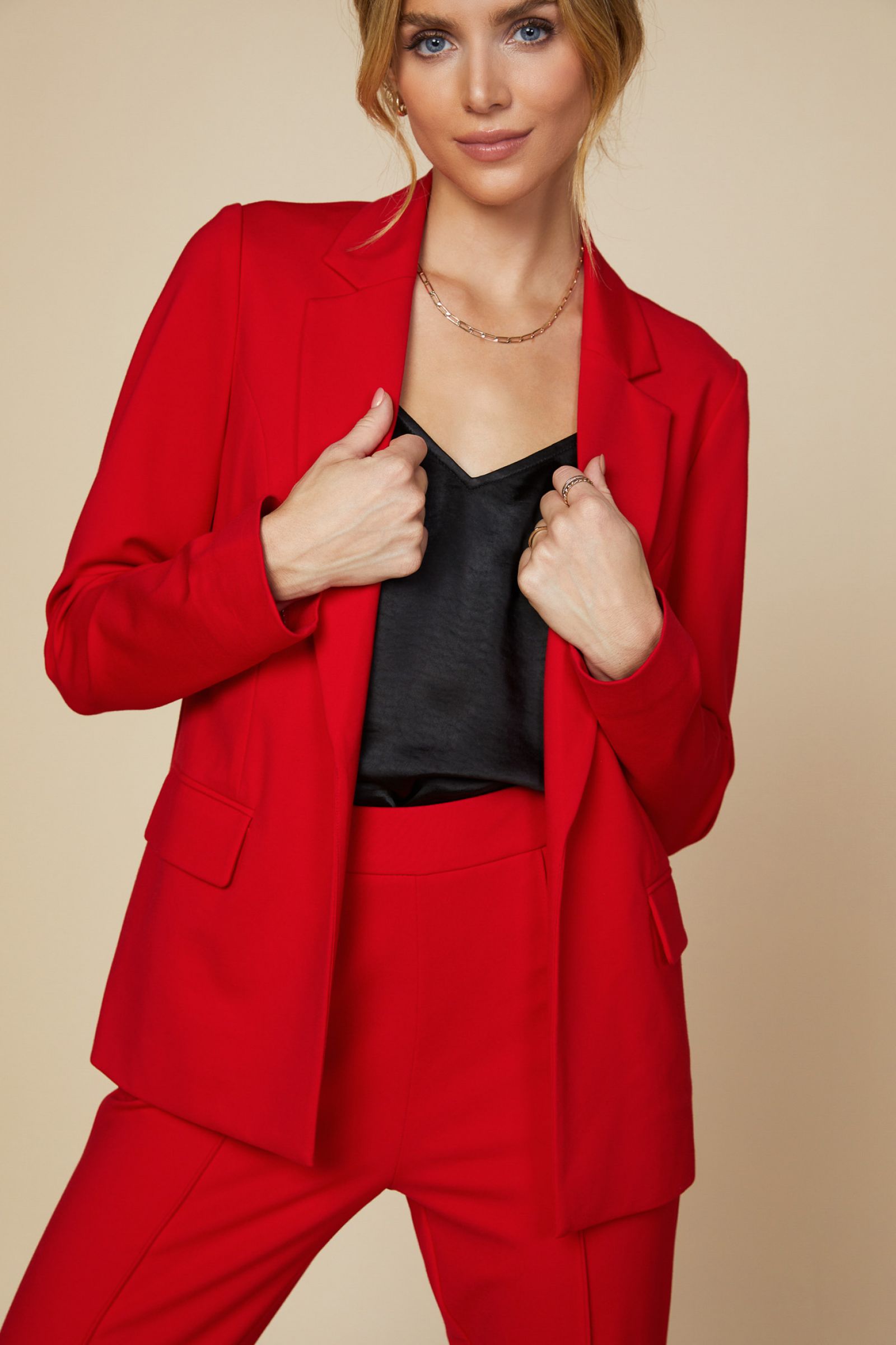 Knit Long Sleeve Red Blazer Jacket in Scarlet Red is stretch and the perfect way to suit up in a comfort. We love the side pockets and printed inner liner for polished look. Add this powerful color to your wardrobe. Don't forget the matching trousers for a matching set. Relaxed Fit 70% Rayon 25% Polyester 5% Spandex