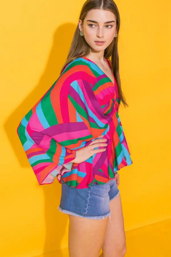 Weezie D. Happy Colors Printed Top sends us on a kaleidoscope of colors. Upscale the look with a pencil skirt & heels for ladies brunch or a more casual look with denim to date night. Dolman drop long sleeves flow with each movement. V-Neckline & relaxed fit. Great quality & feels like silk on your skin 100% Polyester