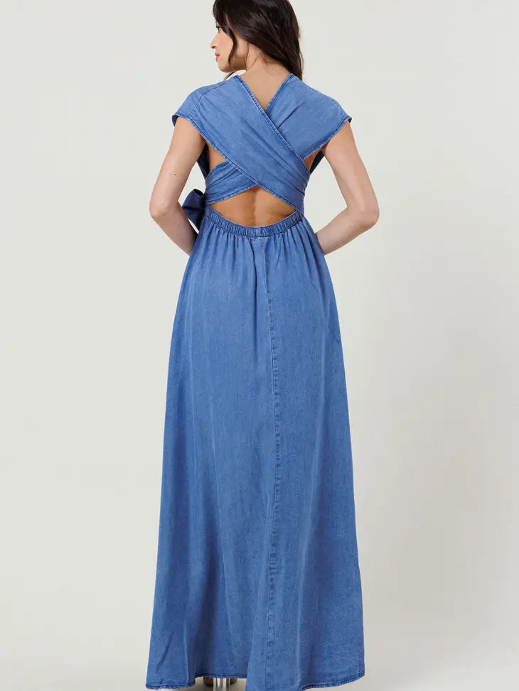 Weezie D Indigo Blue Tencel Cut Out Maxi Wrap Dress can be worn many ways. Made of soft 100% Tencel fabric will flow with your every movement. Wrap the long straps many different ways. The model has hers wrapped into a front bow and peek a boo cutout back. Elastic Waist for added comfort. Pull Over Style. 100% Tencel