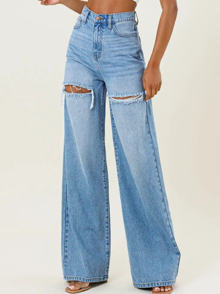Weezie D light blue wash High Waist Distressed Wide Flood Denim Jeans are a MUST HAVE. Classic 5 pocket construction, hidden zip fly closure & belt loops. The thigh slit cuts add character to our denim. We love how the high waist fits with shorter length tops, t-shirts or tucked in blouse 57.8% Cotton 42.2% Gracell 