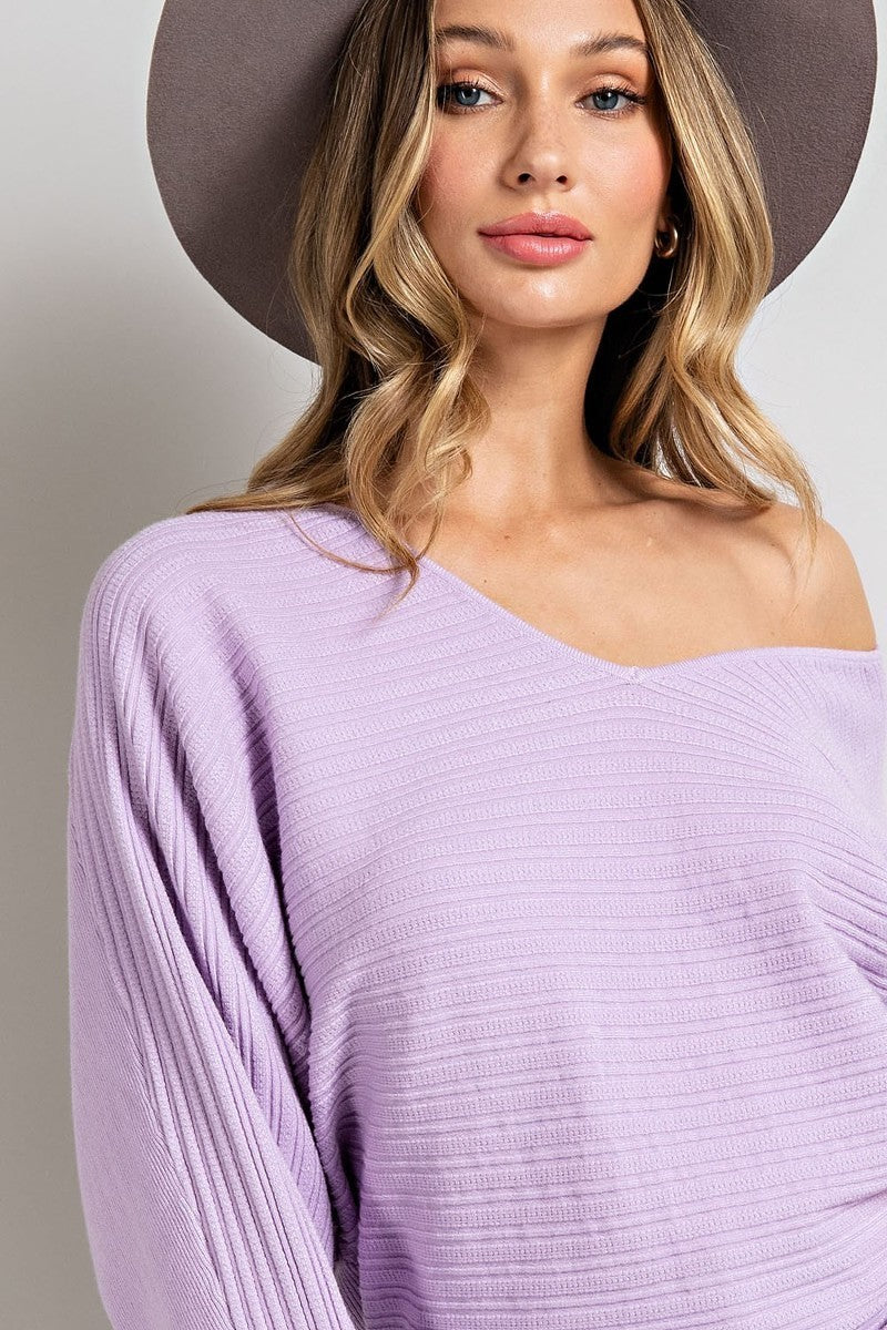 Weezie D. has the perfect lavender Knit V-Neck Sweater Top for you. It's soft and a cozy way to color up your wardrobe right into spring. V-Neckline can be worn off the shoulder. Ribbed fabric detail and long batwing sleeves. Stretch medium knit fabric will fit most. Relaxed Fit 50% Rayon 30% Polyester 20% Cotton